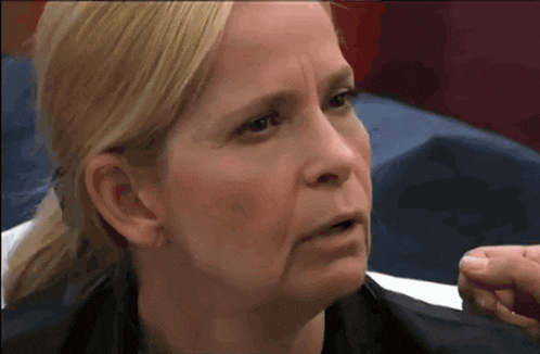 a close up of a woman 's face with a very serious look on her face