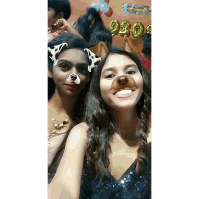 two girls are posing for a picture and one has a dog face mask on her face