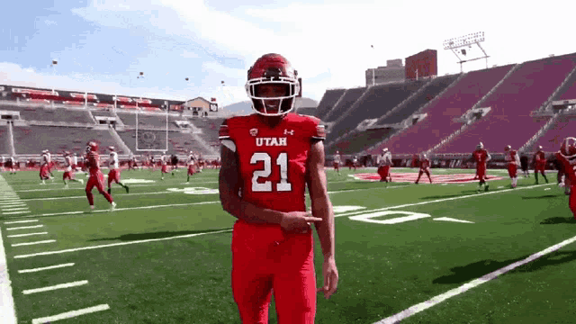 a football player wearing a red jersey with the number 21