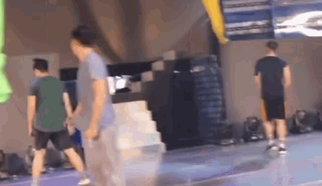 a blurry picture of a group of people standing on a basketball court