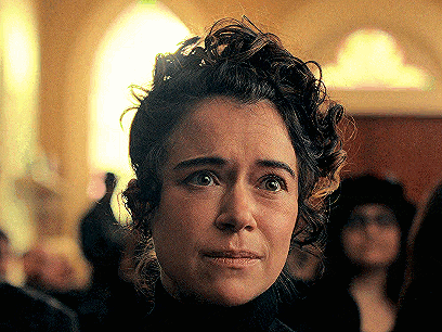 a close up of a woman 's face with a serious look on her face