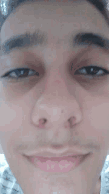 a close up of a man 's face with a smile