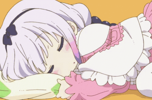 a cartoon girl is sleeping on a pillow on a bed .