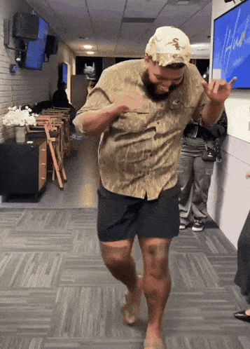 a man wearing a hat with a snake on it is dancing
