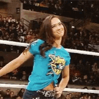 a woman wearing a blue shirt that says smack down