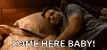 a man is laying in bed with a tablet and a woman is holding his hand .