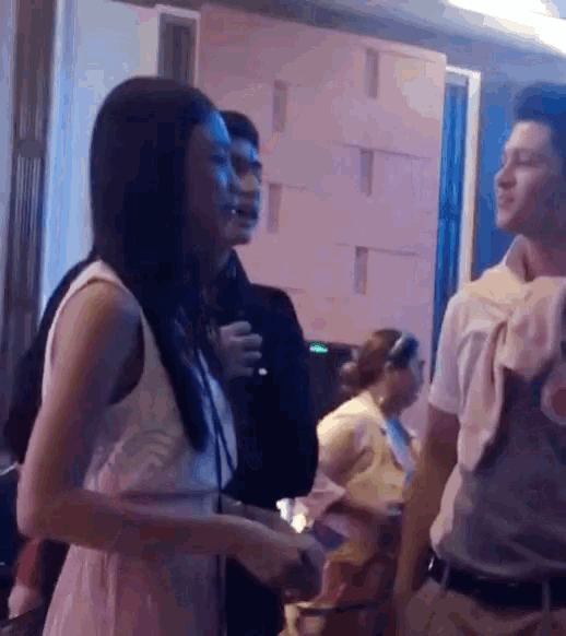 a woman in a white dress is standing next to a man