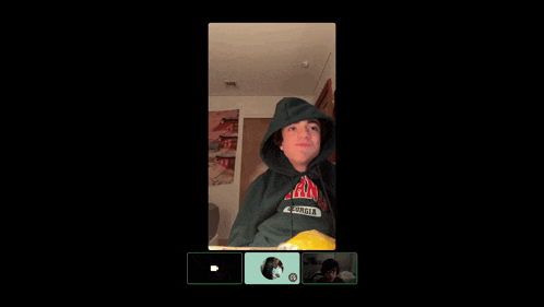a person wearing a green hoodie that says california