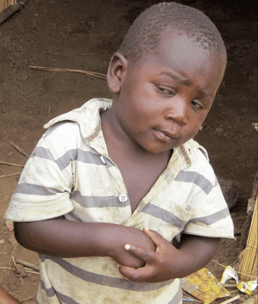 a young boy wearing a striped shirt has a button on his chest that says ' a ' on it