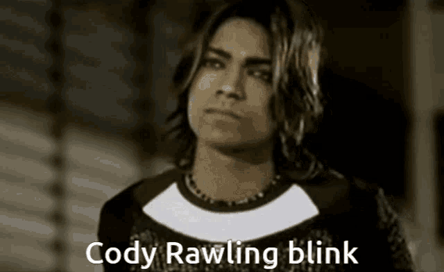a black and white photo of a young man with the words cody rawling blink below him .