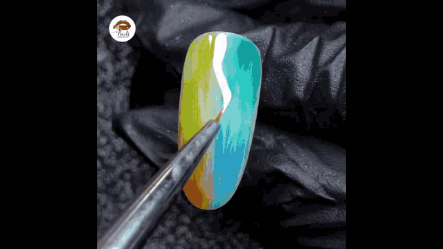 a close up of a nail being painted with a brush that says ' nails ' on it