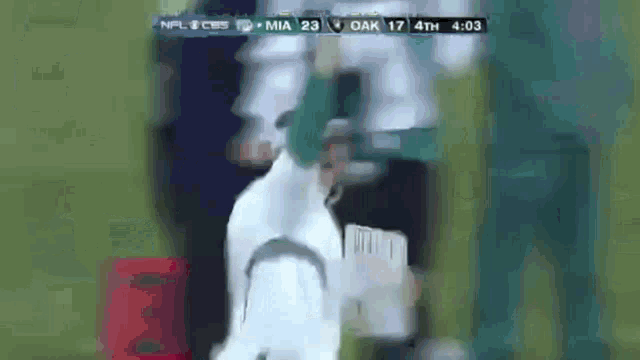 a blurred image of a football game between the jets and the oak