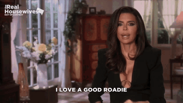 a woman says i love a good roadie in front of a sign that says real housewives out of context