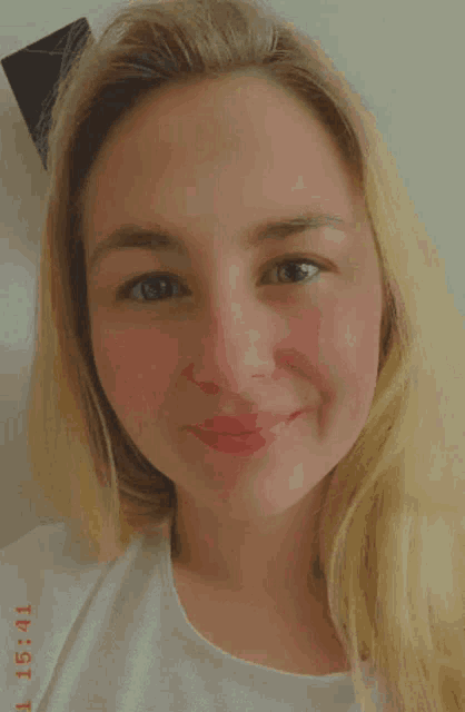 a close up of a woman 's face with the time of 15:41 on the bottom