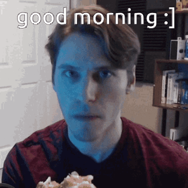 a man in a red shirt is eating a pizza with the words " good morning " above him