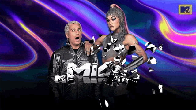 a man and a woman are standing next to each other with the mtv logo in the background