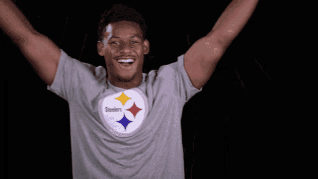 a man wearing a steelers t-shirt is smiling