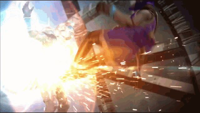 a woman in a purple shirt is being kicked by a man in a blue shirt