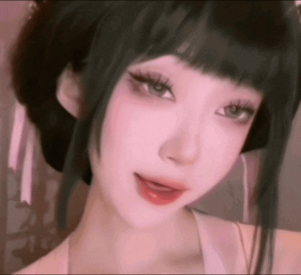a close up of a girl 's face with long black hair and a pink shirt .