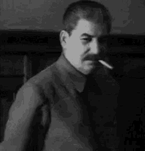 a man with a mustache is smoking a cigarette and drinking a glass of beer .