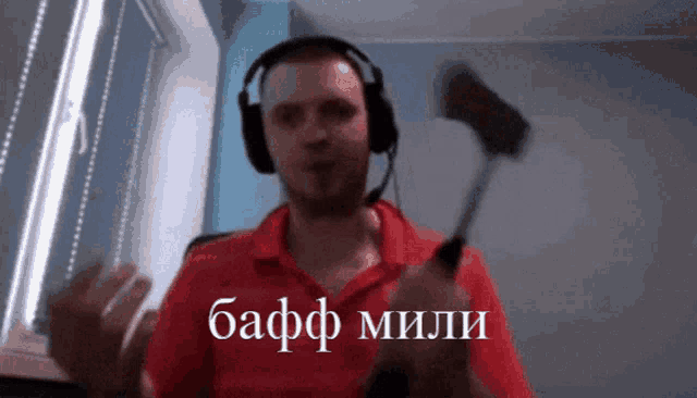 a man wearing headphones is holding a hammer with the word baff mili written on it