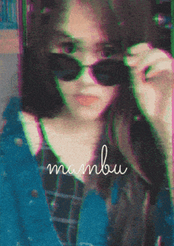 a blurred image of a woman wearing sunglasses with the word mambo on the bottom
