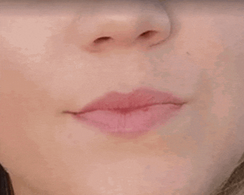 a close up of a man 's face with a blurred background .