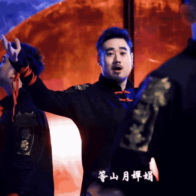 a man in a black jacket has chinese writing on his sleeves