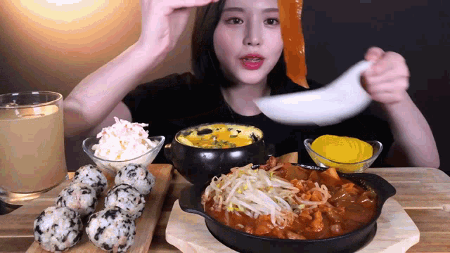 a woman is sitting at a table with a bowl of food