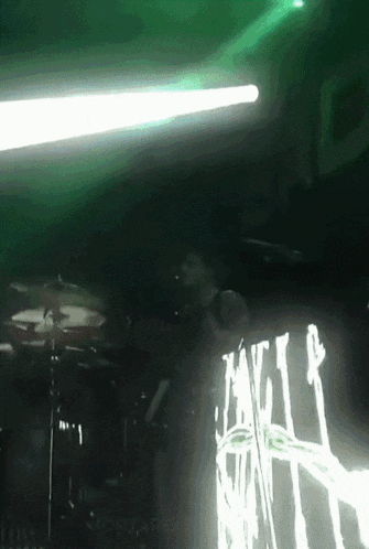 a man playing drums in front of a sign that says mortars