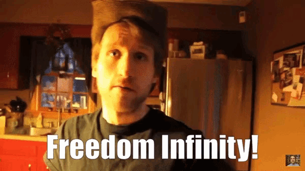 a man in a kitchen with the words freedom infinity on his shirt