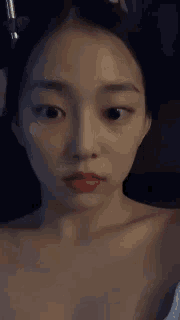 a close up of a woman 's face with red lipstick on her lips