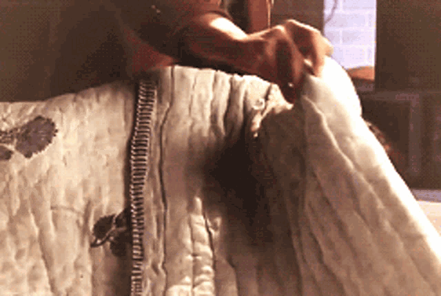 a close up of a person holding a quilt
