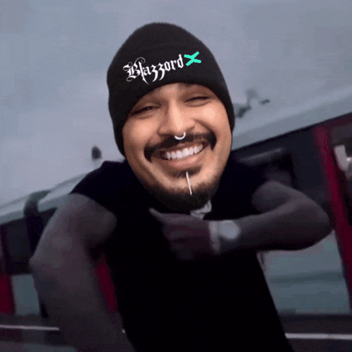 a man wearing a black beanie that says blazzarod x