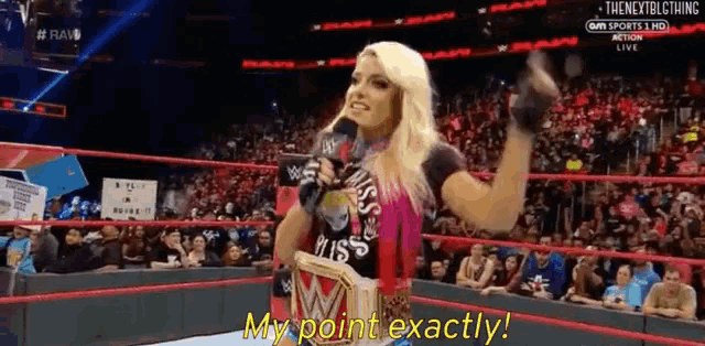 a woman in a wrestling ring is holding a microphone and says my point exactly