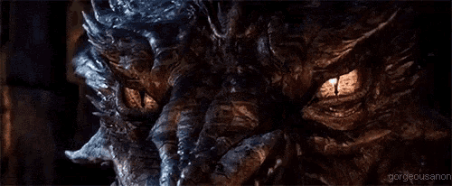 a close up of a dragon 's eyes with glowing yellow eyes .