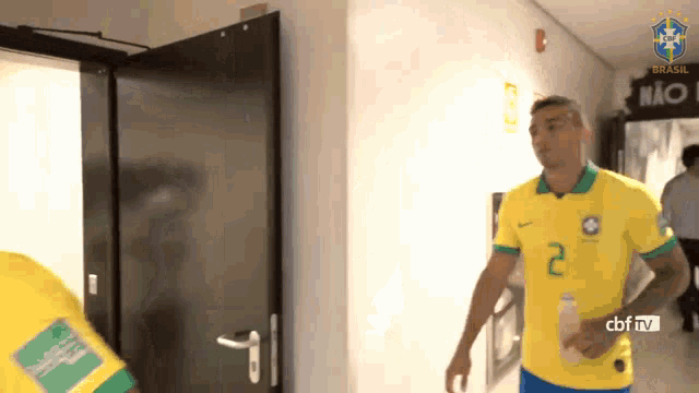 a man in a yellow jersey with the number 2 on it