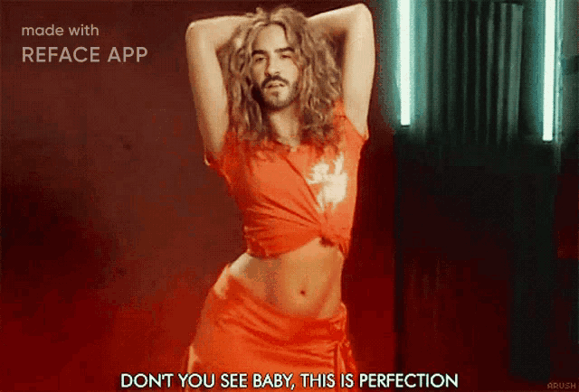 a man with long hair and a beard is dancing in a red dress