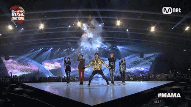 a group of people on a stage with a mnet logo in the corner