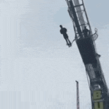 a person is hanging from a bungee jumping machine .