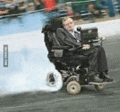 a man in a wheelchair is driving down the road