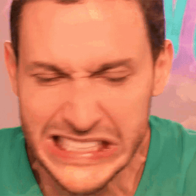 a close up of a man 's face with fire coming out of it
