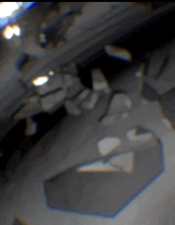 a blurred image of a person 's face with a triangle in the corner