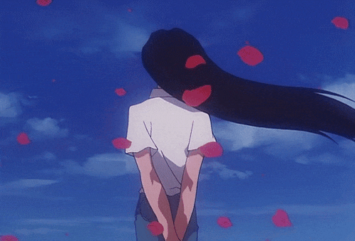 a woman with long hair stands in front of a blue sky