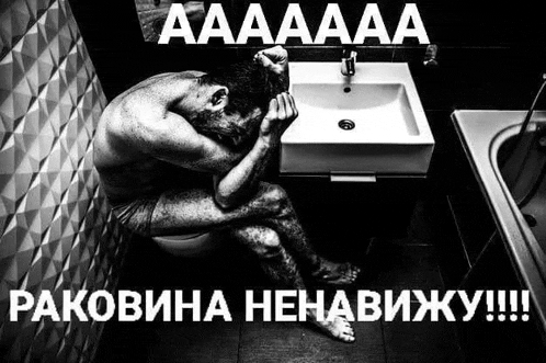 a man is sitting on a toilet in a bathroom with his head on the sink .