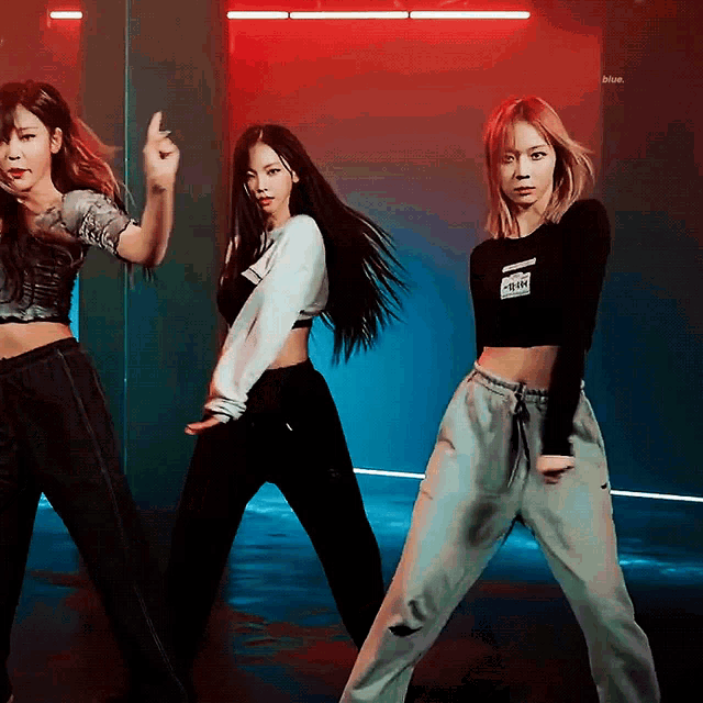 three women are dancing and one has a shirt that says calvin klein on it