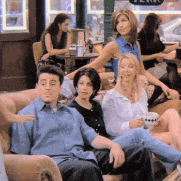 a group of people sitting on a couch in front of a sign that says " perk "