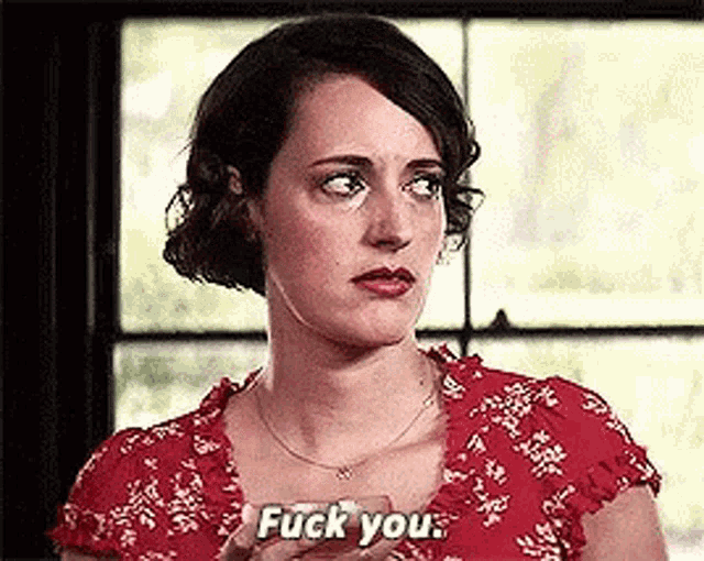 a woman in a red dress is saying `` fuck you '' while holding a glass .