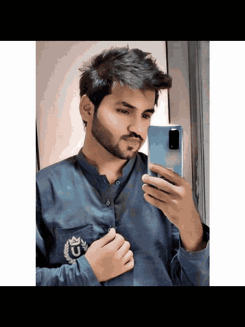 a man with a beard is taking a picture of himself in the mirror