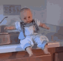 a baby doll is sitting on a counter in a kitchen